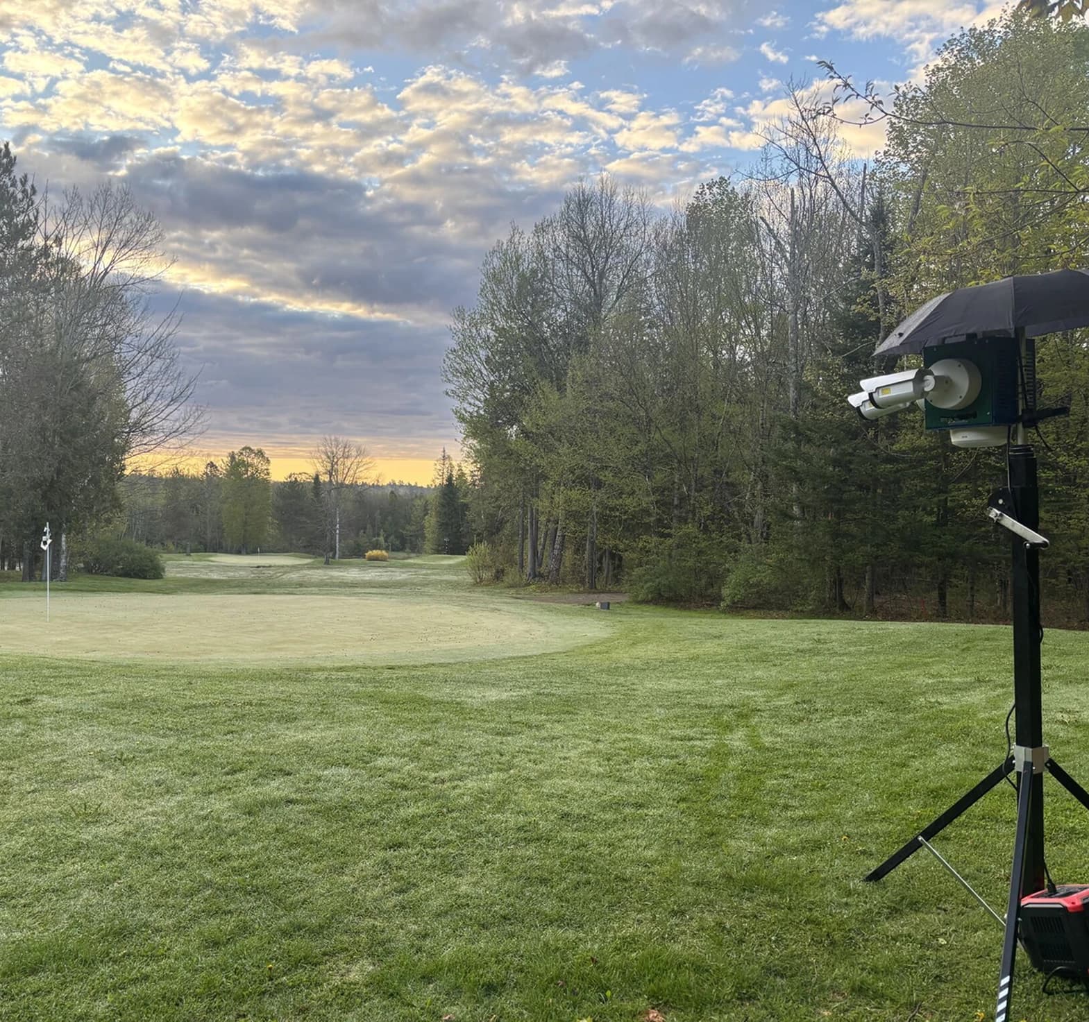 A camera mounted beside a golf course, ready to record golfers’ shots.